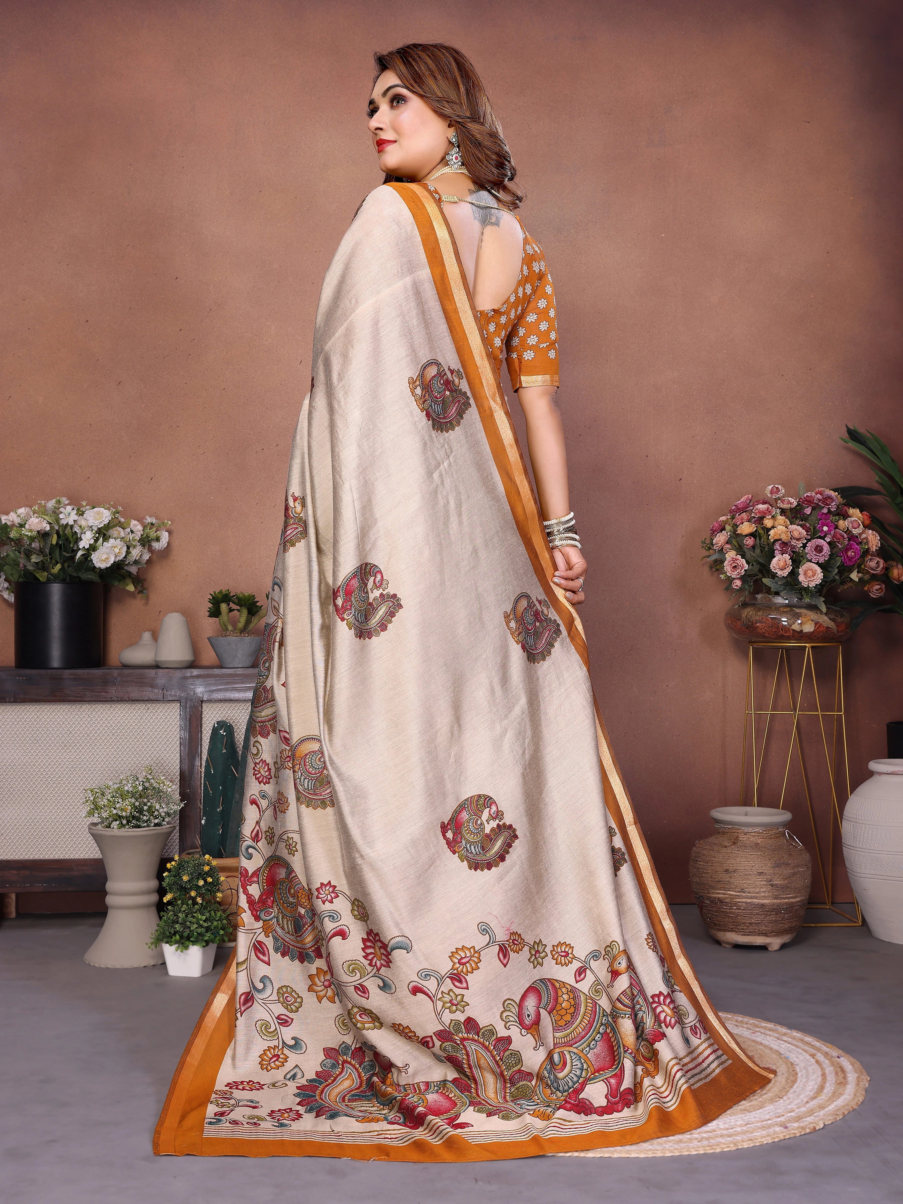 Woman wearing a traditional saree with floral patterns in a decorated indoor setting